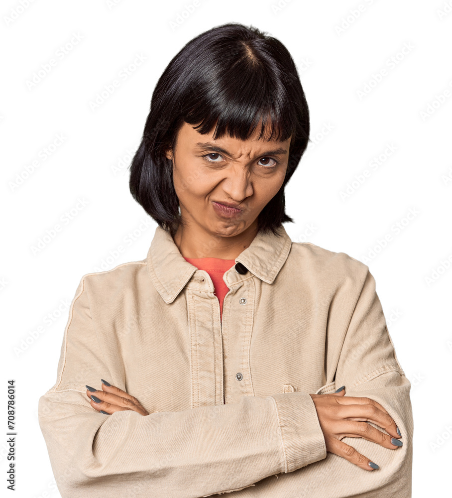 Young Hispanic woman with short black hair in studio suspicious, uncertain, examining you.