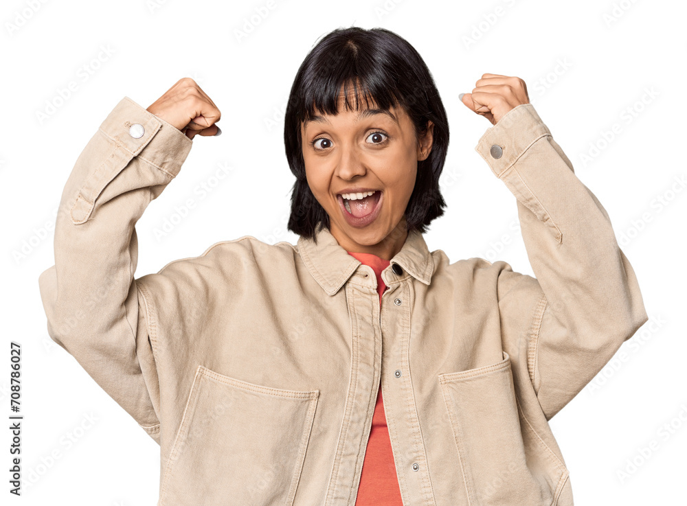 Young Hispanic woman with short black hair in studio showing strength gesture with arms, symbol of feminine power Young Hispanic woman with short black hair in studio showing strength gesture with arms, symbol of feminine power