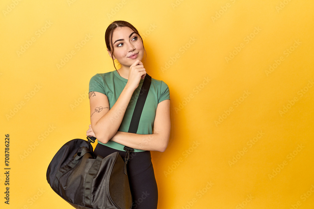Athletic caucasian woman with sports backpack looking sideways with doubtful and skeptical expression. Athletic caucasian woman with sports backpack looking sideways with doubtful and skeptical expression.