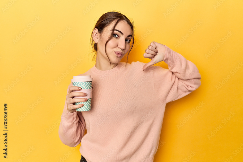 Young caucasian woman holding a takeaway coffee cup feels proud and self confident, example to follow. Young caucasian woman holding a takeaway coffee cup feels proud and self confident, example to follow.