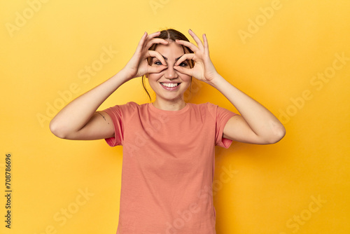 showing okay sign over eyes photo