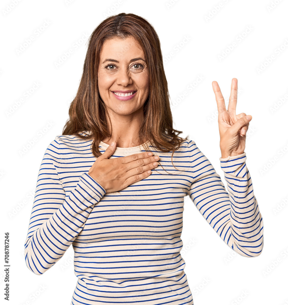 Middle-aged woman portrait in studio setting taking an oath, putting hand on chest. Middle-aged woman portrait in studio setting taking an oath, putting hand on chest.