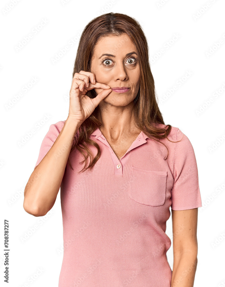 Middle-aged woman portrait in studio setting with fingers on lips keeping a secret. Middle-aged woman portrait in studio setting with fingers on lips keeping a secret.