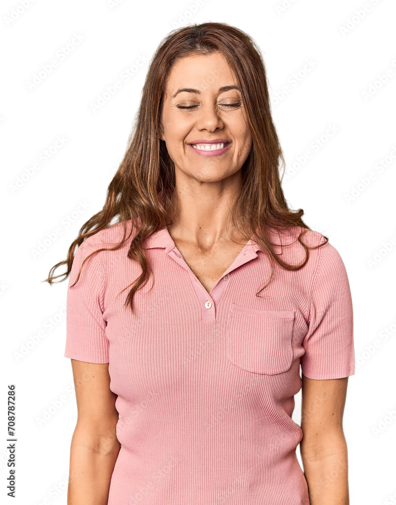 Middle-aged woman portrait in studio setting laughs and closes eyes, feels relaxed and happy. Middle-aged woman portrait in studio setting laughs and closes eyes, feels relaxed and happy.