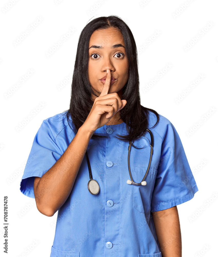 Young Filipina nurse posed in studio keeping a secret or asking for silence. Young Filipina nurse posed in studio keeping a secret or asking for silence.