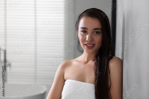 Free Download Smiling young woman after shower in bathroom. Space for text - GFXLoad