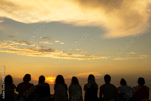 Group of people looking at sunset