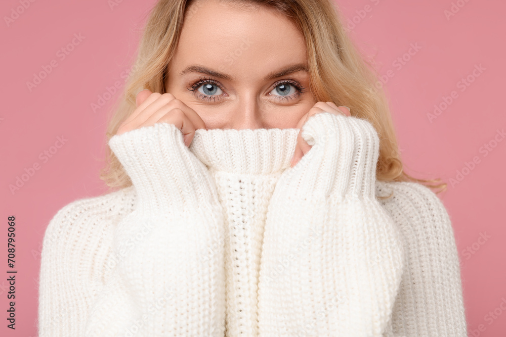 Beautiful woman in stylish warm sweater on pink background Beautiful woman in stylish warm sweater on pink background
