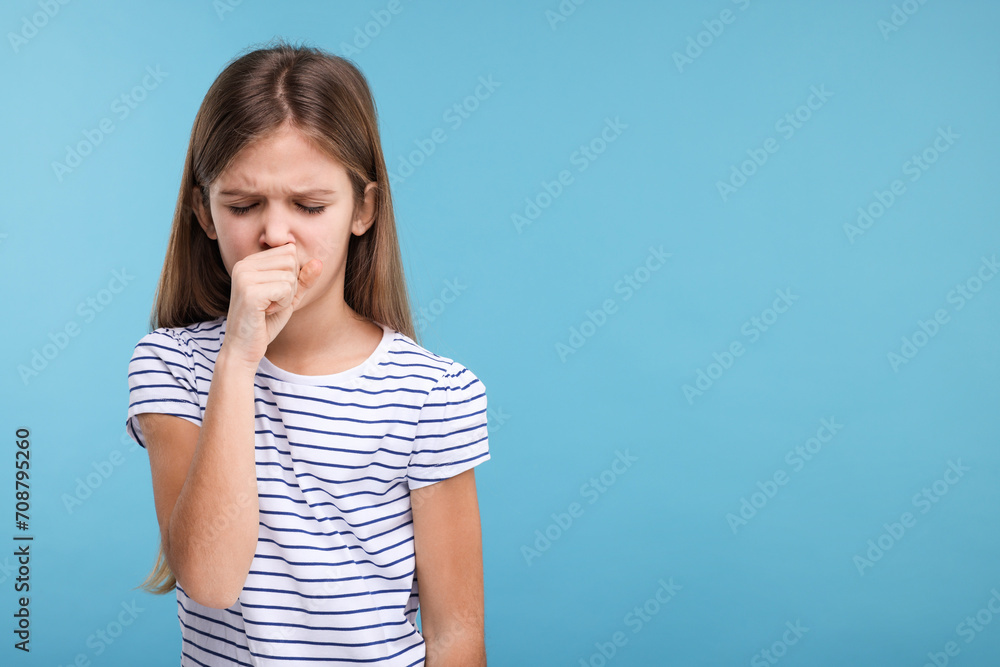 Sick girl coughing on light blue background, space for text Sick girl coughing on light blue background, space for text