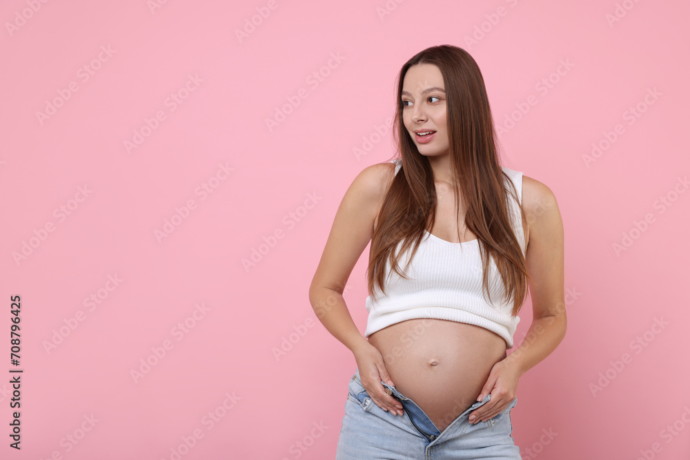 Beautiful pregnant woman with long hair on pink background, space for text Beautiful pregnant woman with long hair on pink background, space for text
