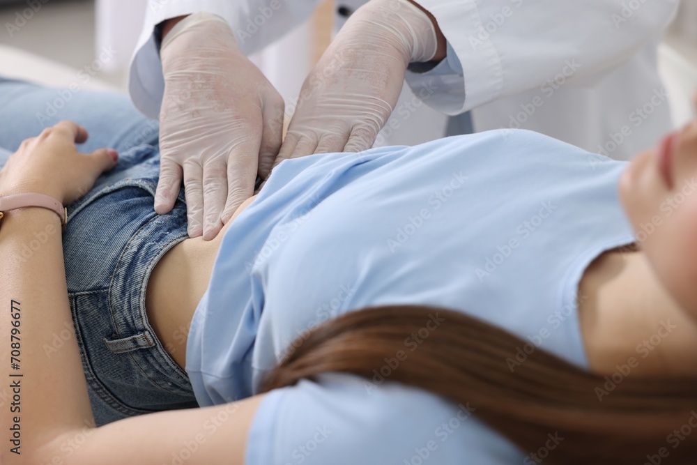 Gastroenterologist examining patient with stomach pain in clinic, closeup - obrazy, fototapety, plakaty 