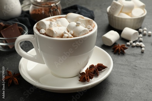 Tasty hot chocolate with marshmallows on dark textured table, closeup