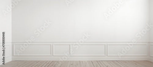 A vacant space with white walls, wooden flooring, and a door to another room.