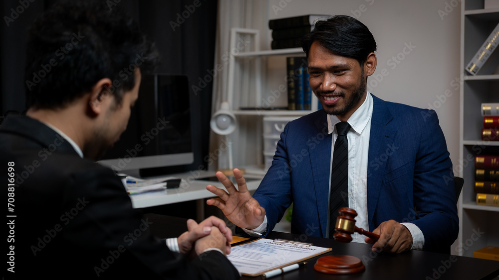 A lawyer is meeting with a new client, a young man in a suit and tie sits at the table. Share legal advice Explain the inheritance process Legal and financial business concepts A lawyer is meeting with a new client, a young man in a suit and tie sits at the table. Share legal advice Explain the inheritance process Legal and financial business concepts