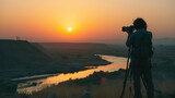 Filmmaker overlooking valley sunset
