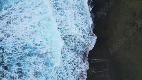 Play of waves on a black sand beach