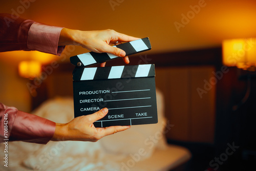 Hand Holding a Film Slate in a Bedroom. Director making an independent motion picture with limited budget
 photo