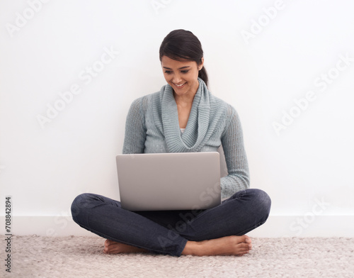 Happy woman, laptop and relax on floor for communication, email or online research at home. Young female person or freelancer smile in remote work on computer for search, networking or streaming