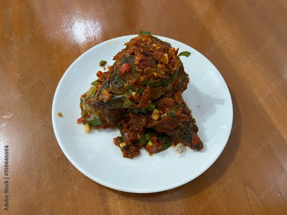 Indonesian traditional dish named Ikan Tuna Balado which is made from fried tuna fish with chili, garlic, shallot and other spices Indonesian traditional dish named Ikan Tuna Balado which is made from fried tuna fish with chili, garlic, shallot and other spices