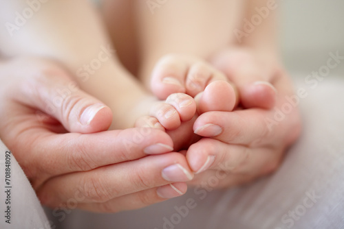 Love, mother and hands with baby or feet for development, nurture and bonding in nursery of apartment. Family, woman or newborn toes with relax, support or care for relationship or motherhood in home