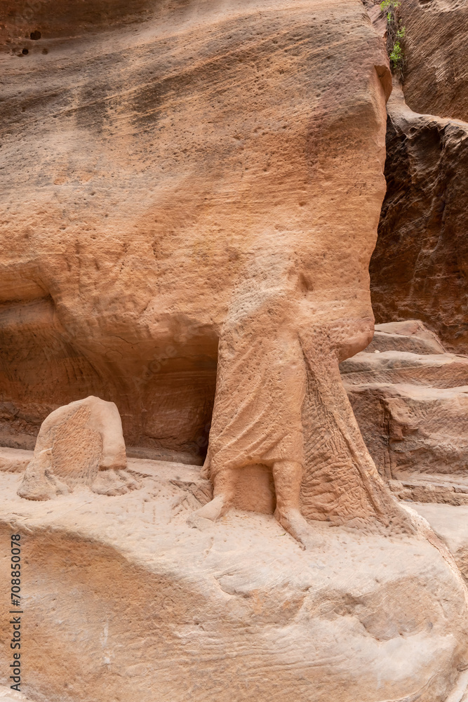 Partially preserved sculpture of a camel driver and a camel carved into sand rock of Al Siq gorge in Nabatean Kingdom of Petra in the Wadi Musa city in Jordan Partially preserved sculpture of a camel driver and a camel carved into sand rock of Al Siq gorge in Nabatean Kingdom of Petra in the Wadi Musa city in Jordan