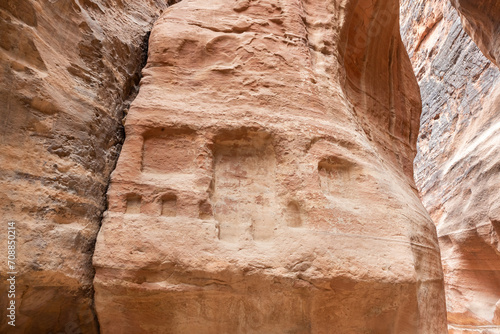 Pagan Nabatean altar protecting from evil demons carved into the sand wall of the Al Siq gorge in Nabatean Kingdom of Petra in the Wadi Musa city in Jordan