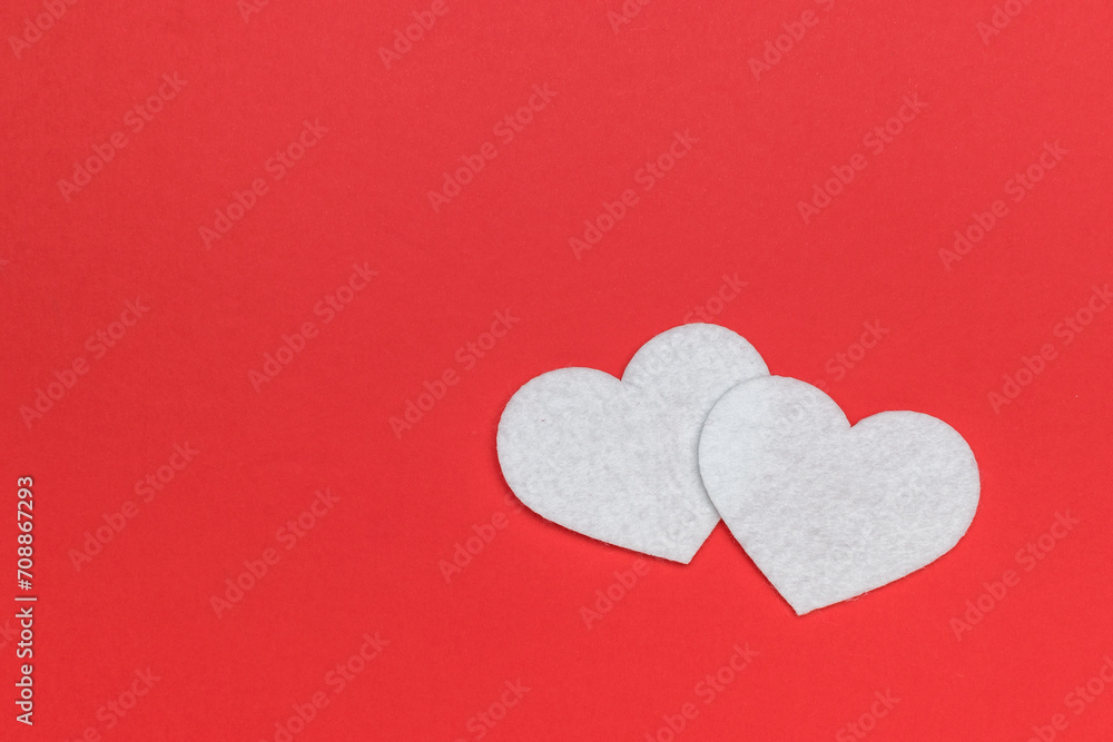 Two white hearts on a bright red background.