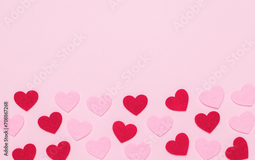 A large number of red and pink hearts on a pink background.