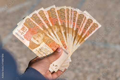 Εκτύπωση καμβά boy holding pakistan currency notes worth of five thousand rupees in hands