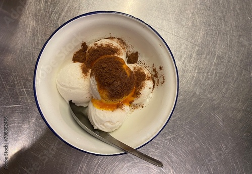 Coops of ice cream served on top egg yolk and chocolate 