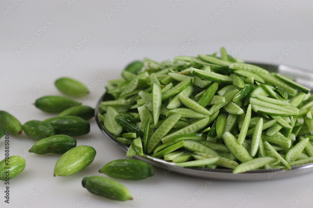 Heap of Ivy gourd or Kovaka vegetables, meticulously sliced lengthwise. Heap of Ivy gourd or Kovaka vegetables, meticulously sliced lengthwise.