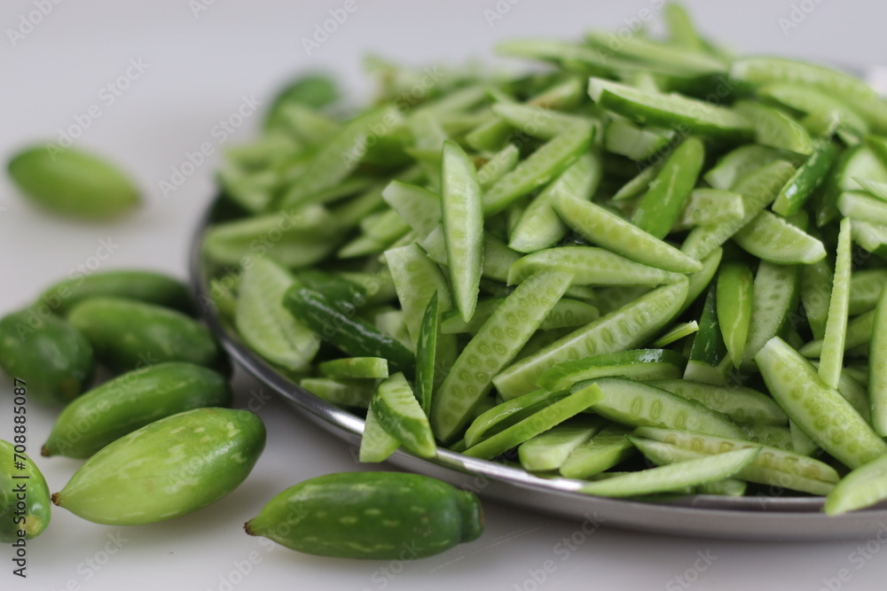 Heap of Ivy gourd or Kovaka vegetables, meticulously sliced lengthwise. Heap of Ivy gourd or Kovaka vegetables, meticulously sliced lengthwise.