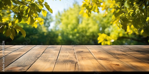 Empty wooden table for product placement in front of green nature background photo