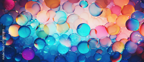 Macro texture of colorful soap bubbles in motion, with a clear, shiny appearance.