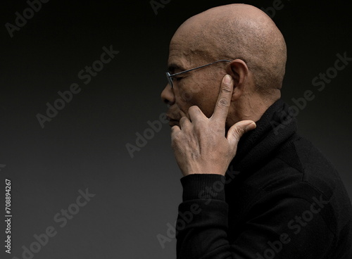 deafness suffering from hearing loss on grey black background with people stock image stock photo  © herlanzer