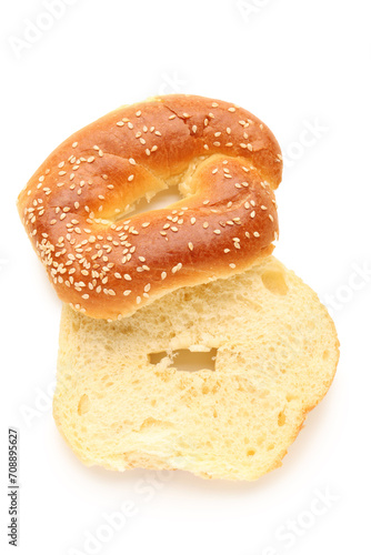 Halves of tasty bagel with sesame seeds on white background © Pixel-Shot