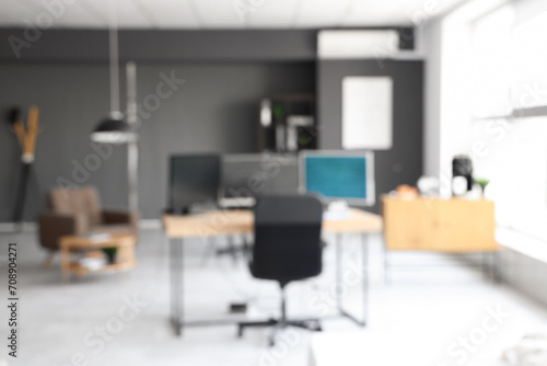 Blurred view of modern office with computers