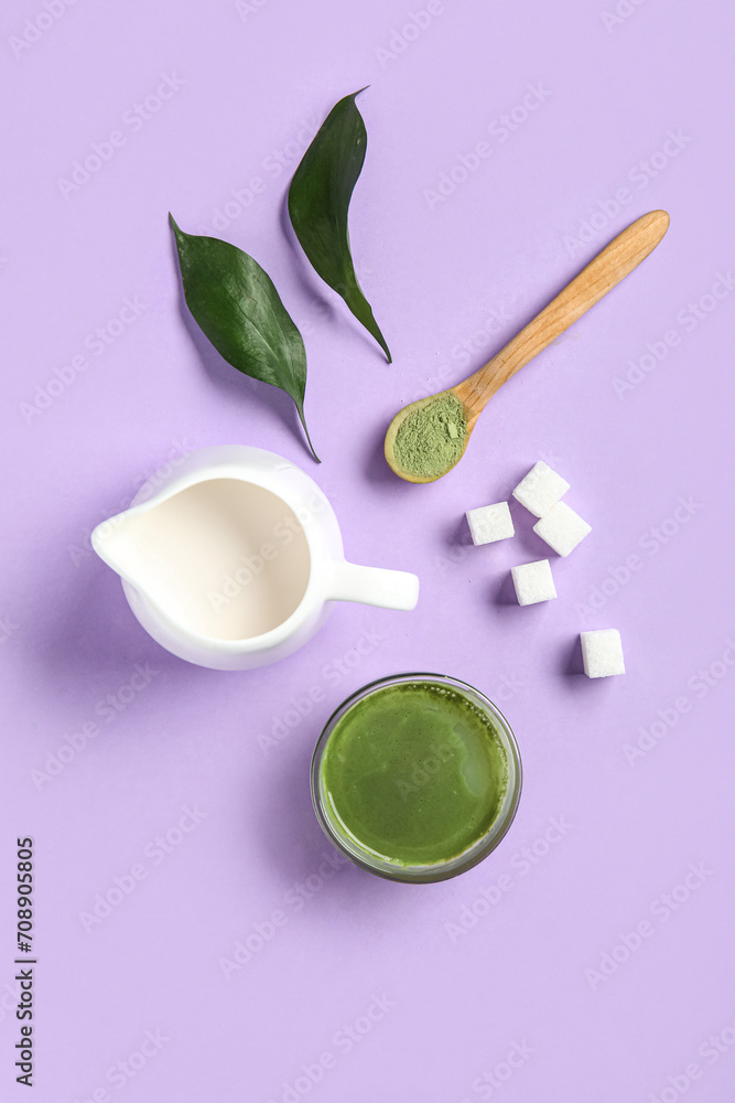 Composition with cup of fresh matcha tea, milk and sugar on lilac background