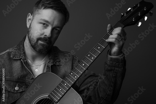 Cuadro en lienzo Close up portrait of a caucasian man in his 40s holding and posing with an acoustic guitar