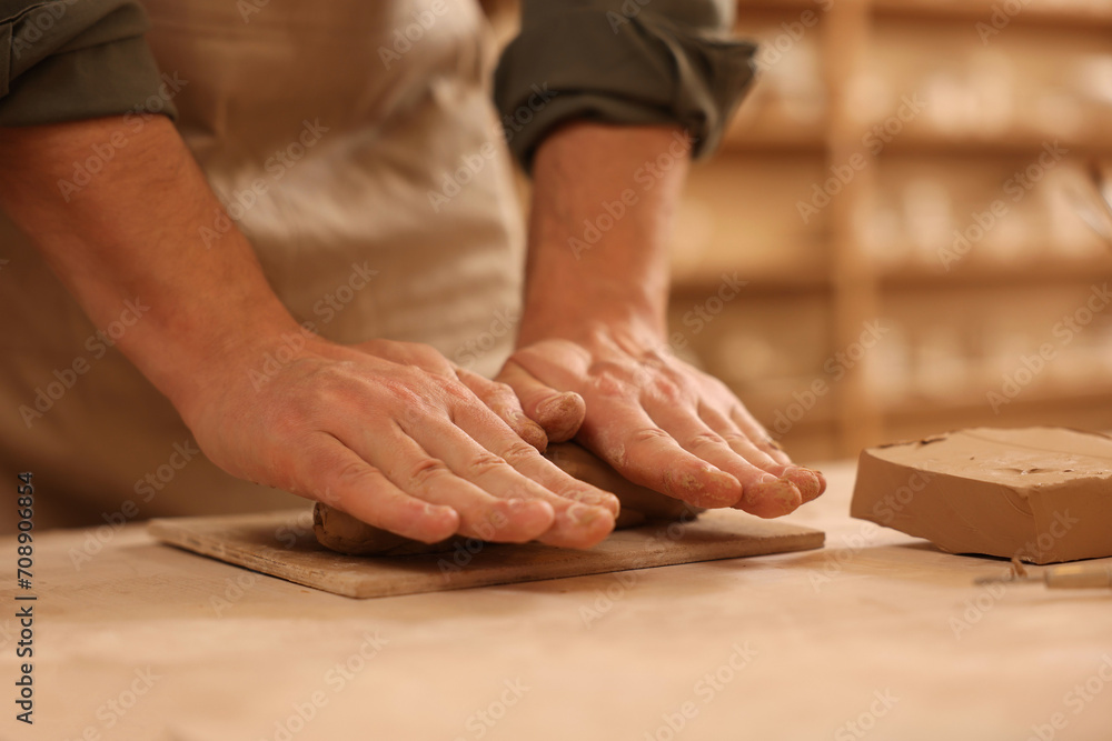Man crafting with clay at table indoors, closeup Man crafting with clay at table indoors, closeup