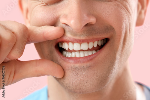 Male dentist smiling on pin...