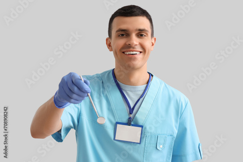 Young male dentist with pro...