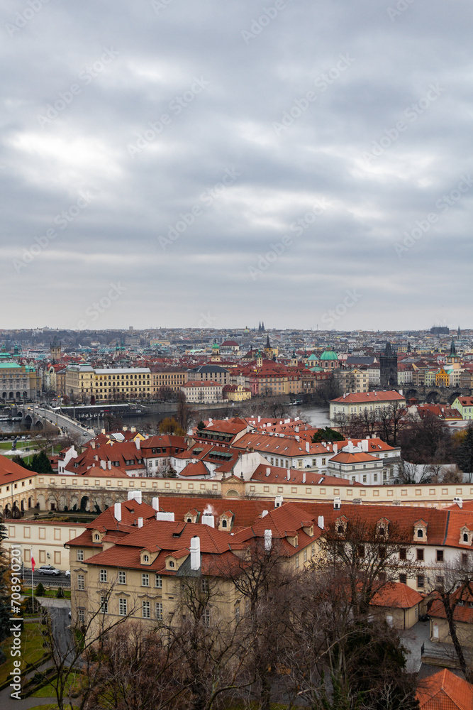 Panoramic view of the medieval city Prague during winter. You can the Charles bridge and skycrapers in the distance. The wather was cloudy