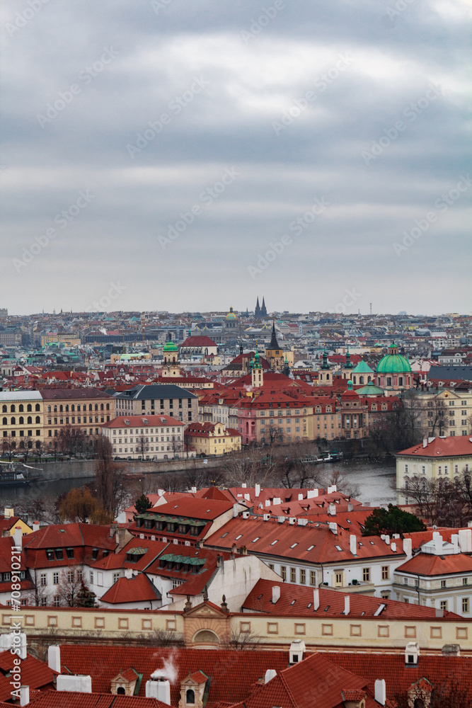 Fototapeta premium Panoramic view of the medieval city Prague during winter. You can the Charles bridge and skycrapers in the distance. The wather was cloudy