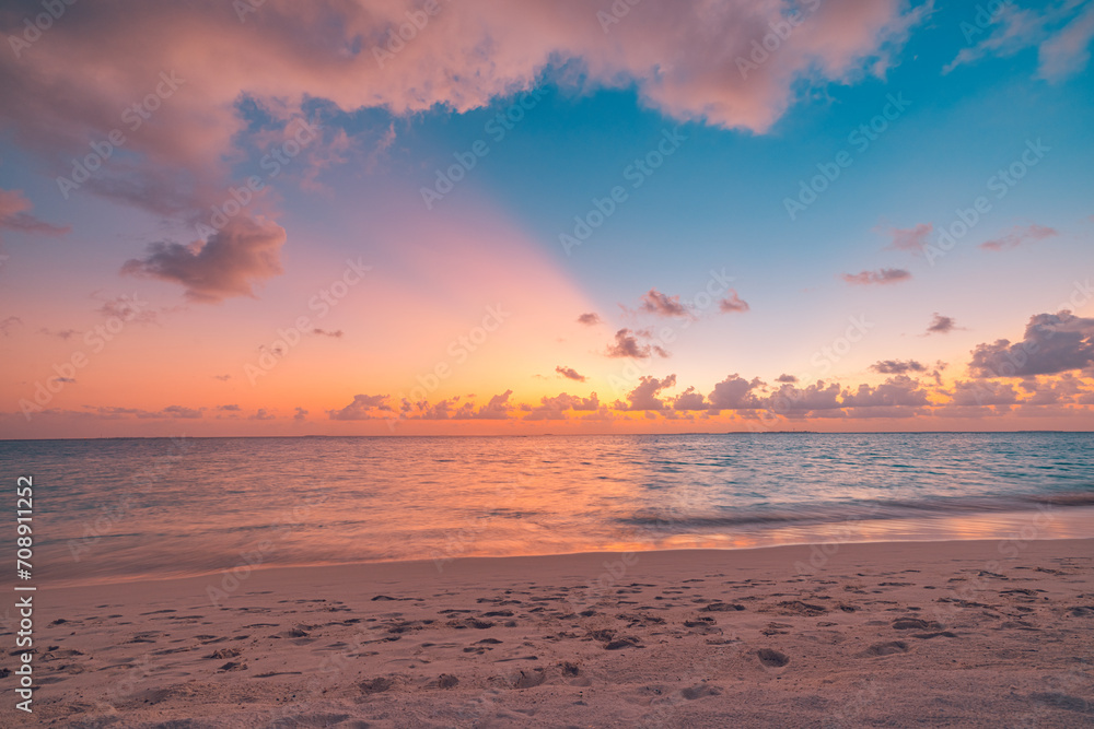 Closeup sea sand beach. Peaceful beach landscape. Inspire tropical beachfront seascape horizon. Orange purple golden sunset sky calmness tranquil relaxing sunlight summer mood. Vacation travel coast