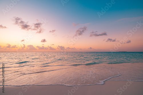 Closeup sea sand beach. Peaceful beach landscape. Inspire tropical beachfront seascape horizon. Orange purple golden sunset sky calmness tranquil relaxing sunlight summer mood. Vacation travel coast © icemanphotos