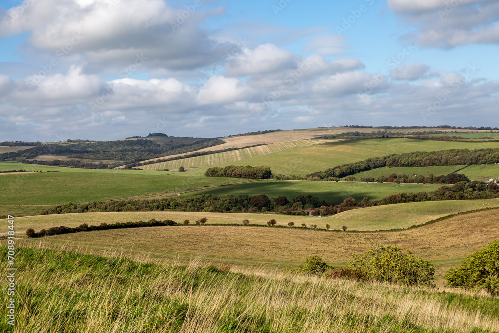 A view in Rural Sussex over farmland, with a blue sky overhead