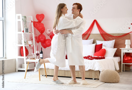 Young couple hugging in bed...