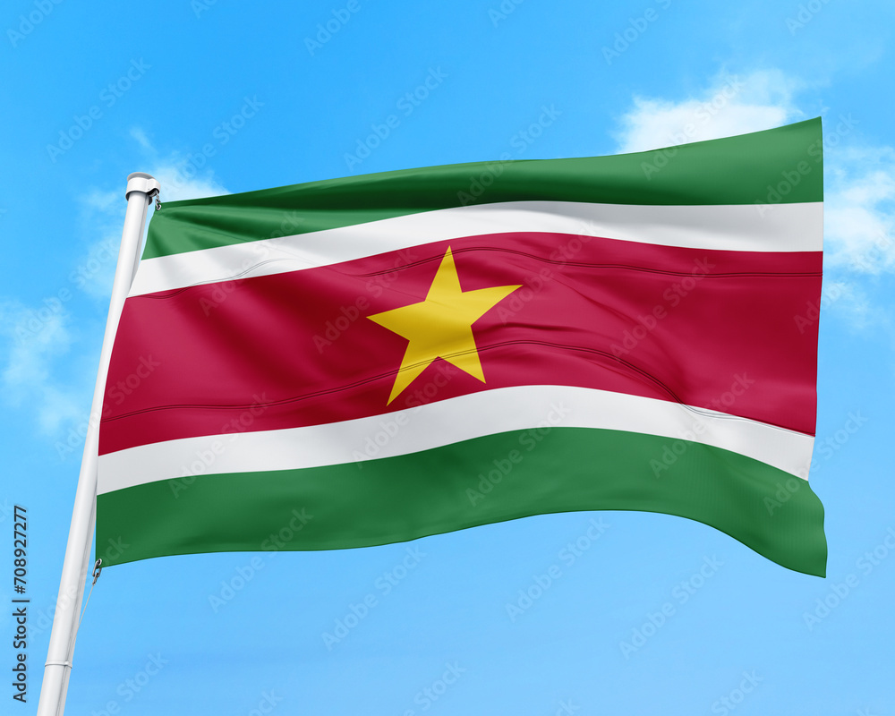 Obraz premium Suriname flag fluttering in the wind on sky.