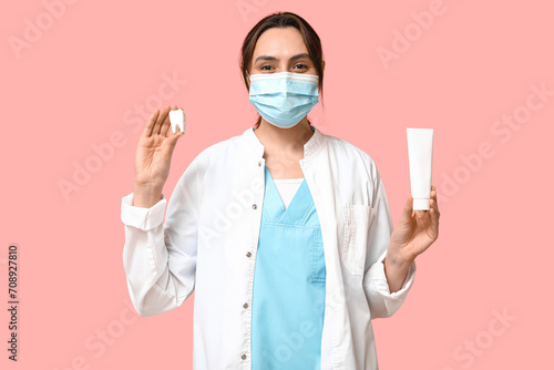 Young female dentist in mas...